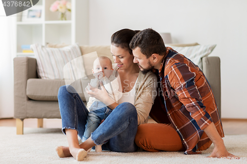 Image of happy family with baby having fun at home