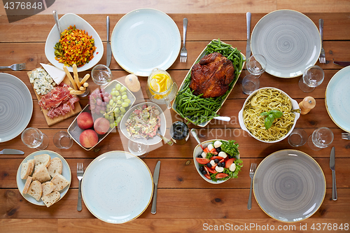 Image of various food on served wooden table