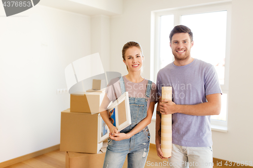 Image of happy couple with boxes moving to new home