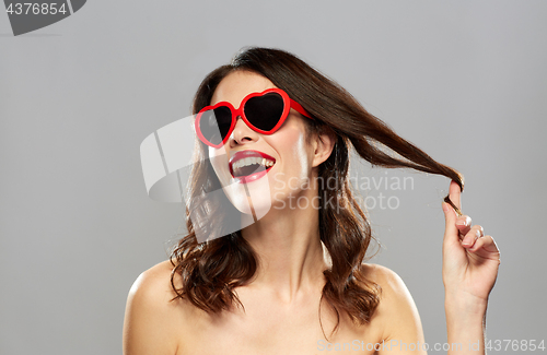 Image of woman with red lipstick and heart shaped shades