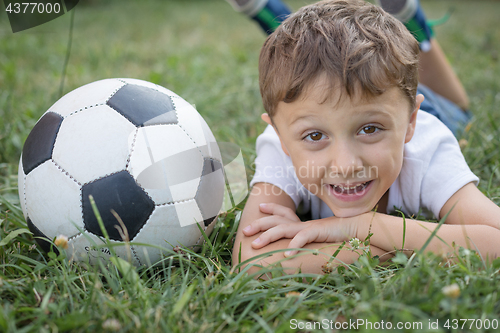 Image of Portrait of a young  boy with soccer ball.