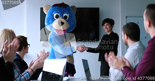 Image of boss dresed as bear having fun with business people in trendy of