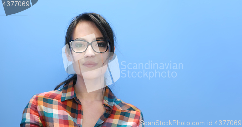 Image of woman smiling wearing on a pair of large glasses