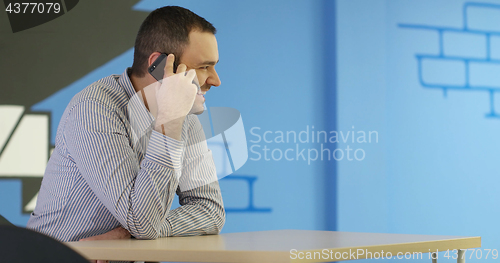 Image of Senior businessman  using cell phone at  stratup office