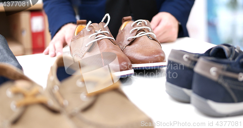 Image of Man Chooses Shoes At Shoe Store