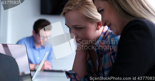 Image of group of business people having a meeting in bright office