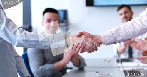 Image of cloasing the deal in modern office interior