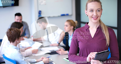 Image of Pretty Businesswoman Using Tablet In Office Building during conf