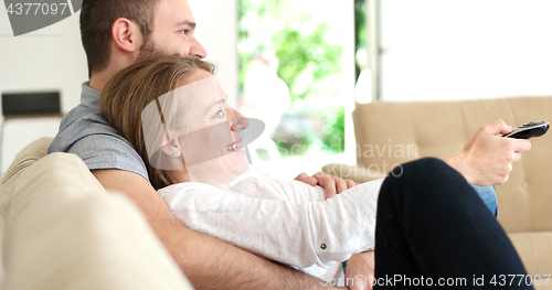 Image of senoior couple watching tv in modern villa