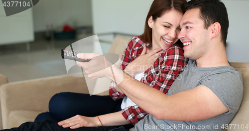 Image of Young Couple Watching Tv at villa