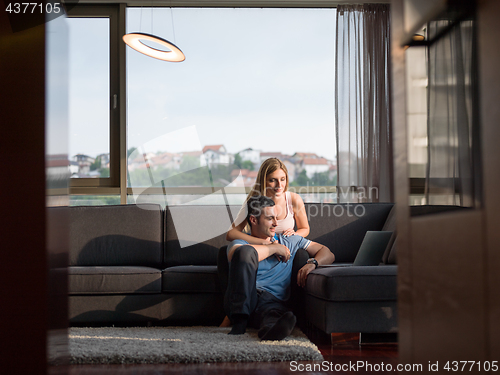 Image of Attractive Couple Using A Laptop on couch