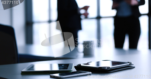 Image of tablet, mobile cell phone and cup of coffee  in office with busi