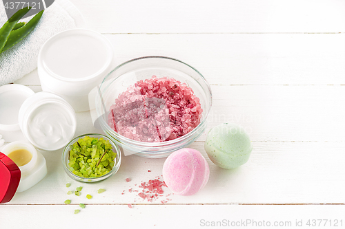 Image of Spa concept with salt, mint, lotion, towel on white background