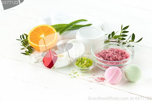 Image of Spa concept with salt, mint, lotion, towel on white background