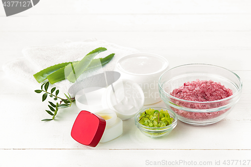 Image of Spa concept with salt, mint, lotion, towel on white background