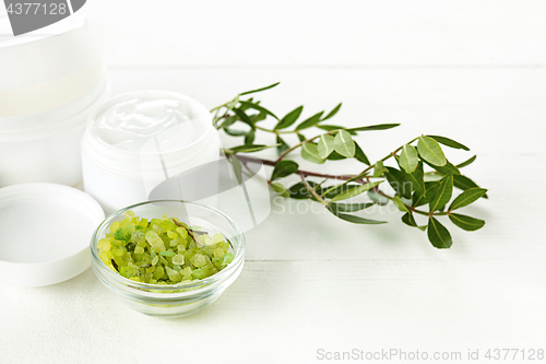 Image of Spa concept with salt, mint, lotion, towel on white background