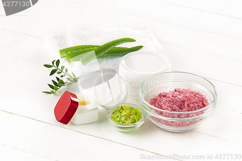 Image of Spa concept with salt, mint, lotion, towel on white background