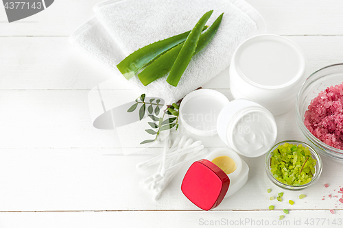 Image of Spa concept with salt, mint, lotion, towel on white background