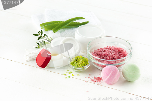 Image of Spa concept with salt, mint, lotion, towel on white background