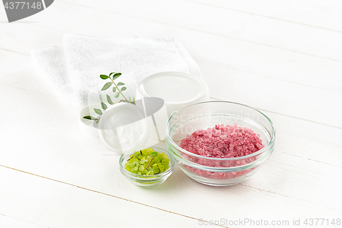 Image of Spa concept with salt, mint, lotion, towel on white background