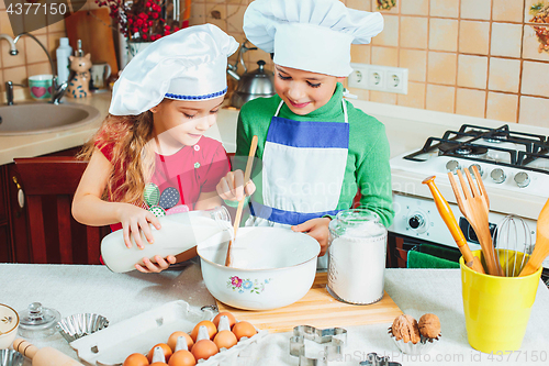 Image of happy family funny kids are preparing the dough, bake cookies in the kitchen