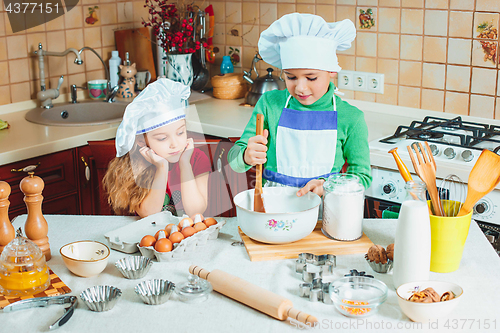 Image of happy family funny kids are preparing the dough, bake cookies in the kitchen