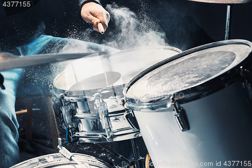 Image of Drummer rehearsing on drums before rock concert. Man recording music on drum set in studio