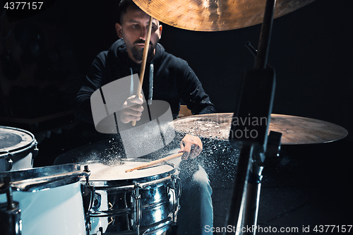 Image of Drummer rehearsing on drums before rock concert. Man recording music on drum set in studio