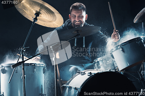 Image of Drummer rehearsing on drums before rock concert. Man recording music on drum set in studio