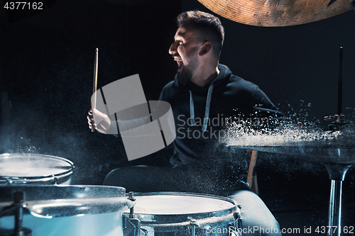 Image of Drummer rehearsing on drums before rock concert. Man recording music on drum set in studio