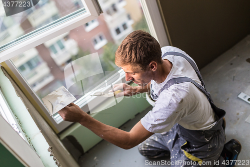 Image of Plasterer renovating indoor walls and ceilings.