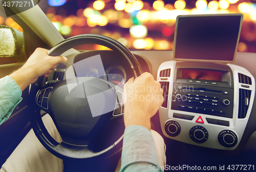 Image of close up of young man with tablet pc driving car