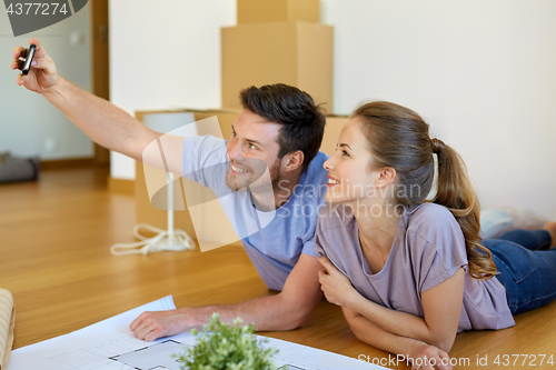 Image of couple taking selfie and moving to new home