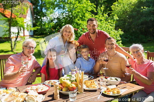 Image of happy family having dinner or summer garden party