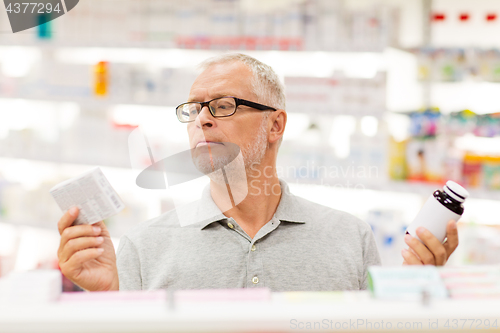 Image of senior male customer choosing drugs at pharmacy