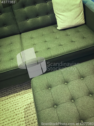 Image of Comfortable green sofa with foot stool