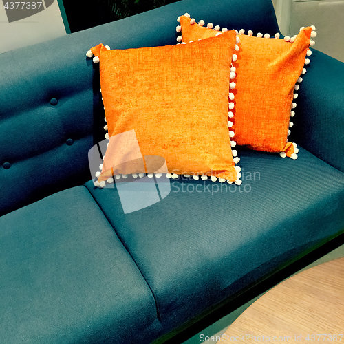 Image of Fancy orange cushions decorating a sofa