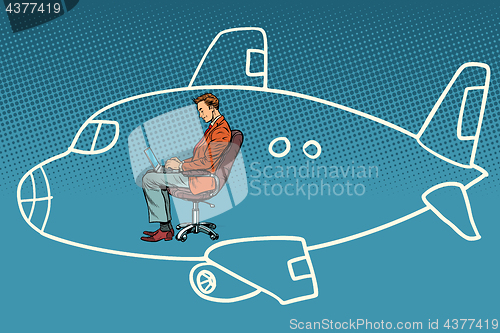 Image of Businessman working on a laptop, dreams of flying in an airplane