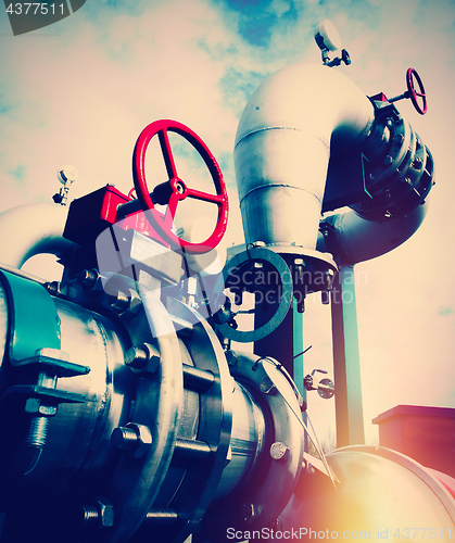 Image of Industrial zone, Steel pipelines and valves against blue sky