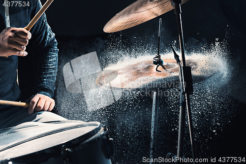 Image of Drummer rehearsing on drums before rock concert. Man recording music on drum set in studio