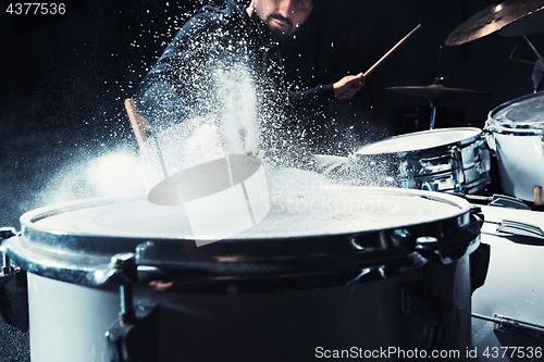 Image of Drummer rehearsing on drums before rock concert. Man recording music on drum set in studio