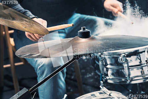 Image of Drummer rehearsing on drums before rock concert. Man recording music on drum set in studio