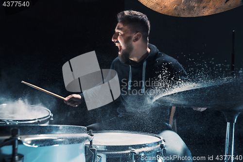 Image of Drummer rehearsing on drums before rock concert. Man recording music on drum set in studio