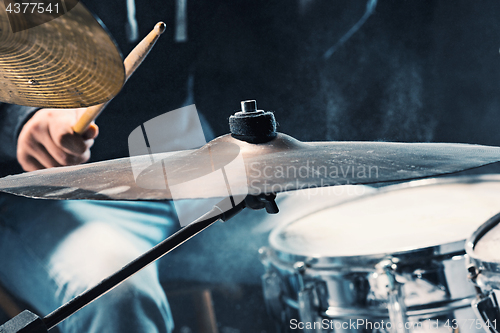 Image of Drummer rehearsing on drums before rock concert. Man recording music on drum set in studio