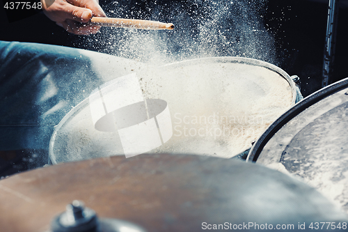 Image of Drummer rehearsing on drums before rock concert. Man recording music on drum set in studio