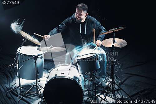 Image of Drummer rehearsing on drums before rock concert. Man recording music on drum set in studio