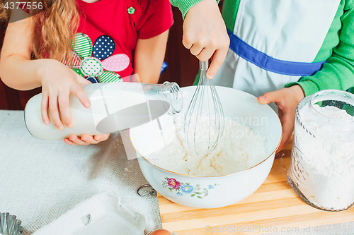 Image of happy family funny kids are preparing the dough, bake cookies in the kitchen