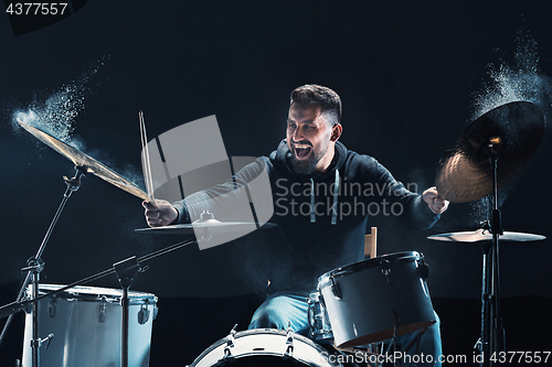 Image of Drummer rehearsing on drums before rock concert. Man recording music on drum set in studio