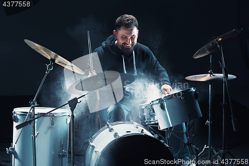 Image of Drummer rehearsing on drums before rock concert. Man recording music on drum set in studio