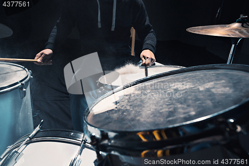 Image of Drummer rehearsing on drums before rock concert. Man recording music on drum set in studio